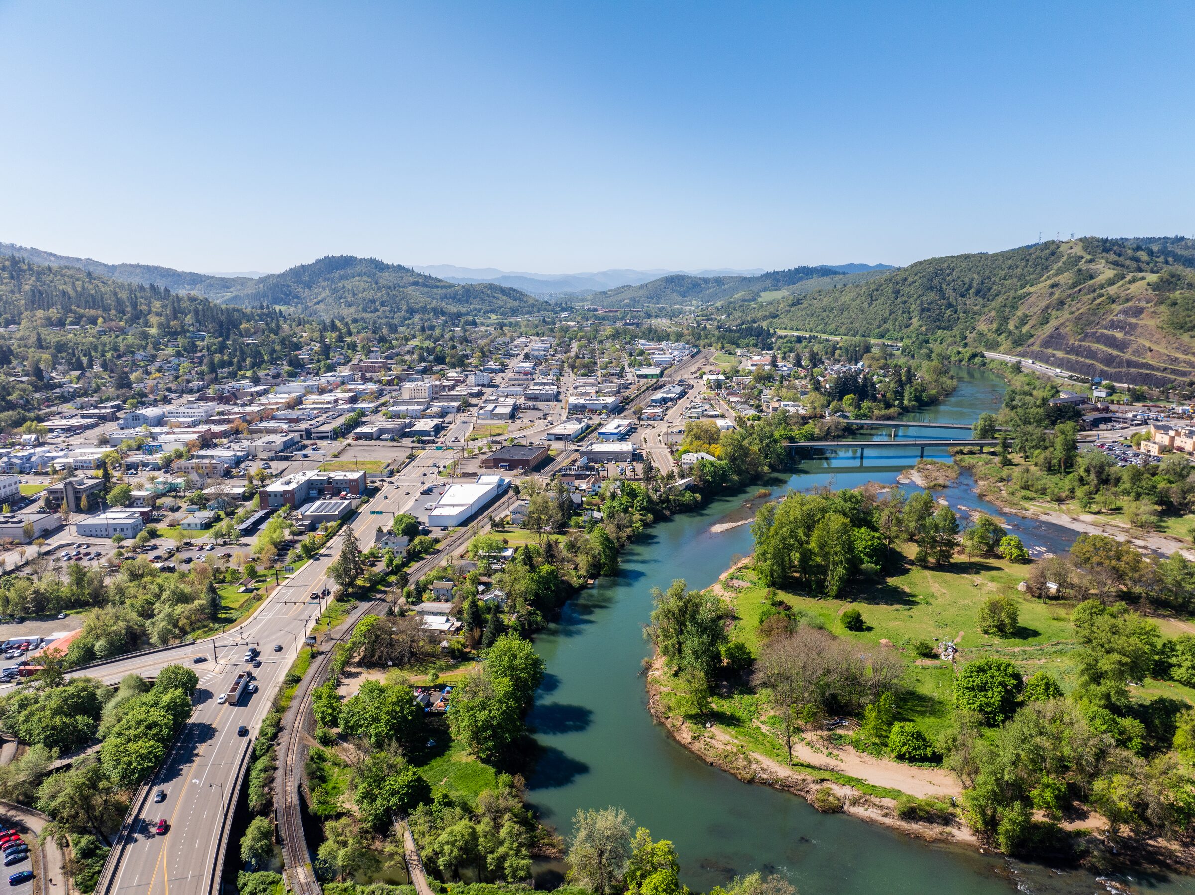 Downtown Roseburg from the air, the South Umpqua River curving past it under wooded hills