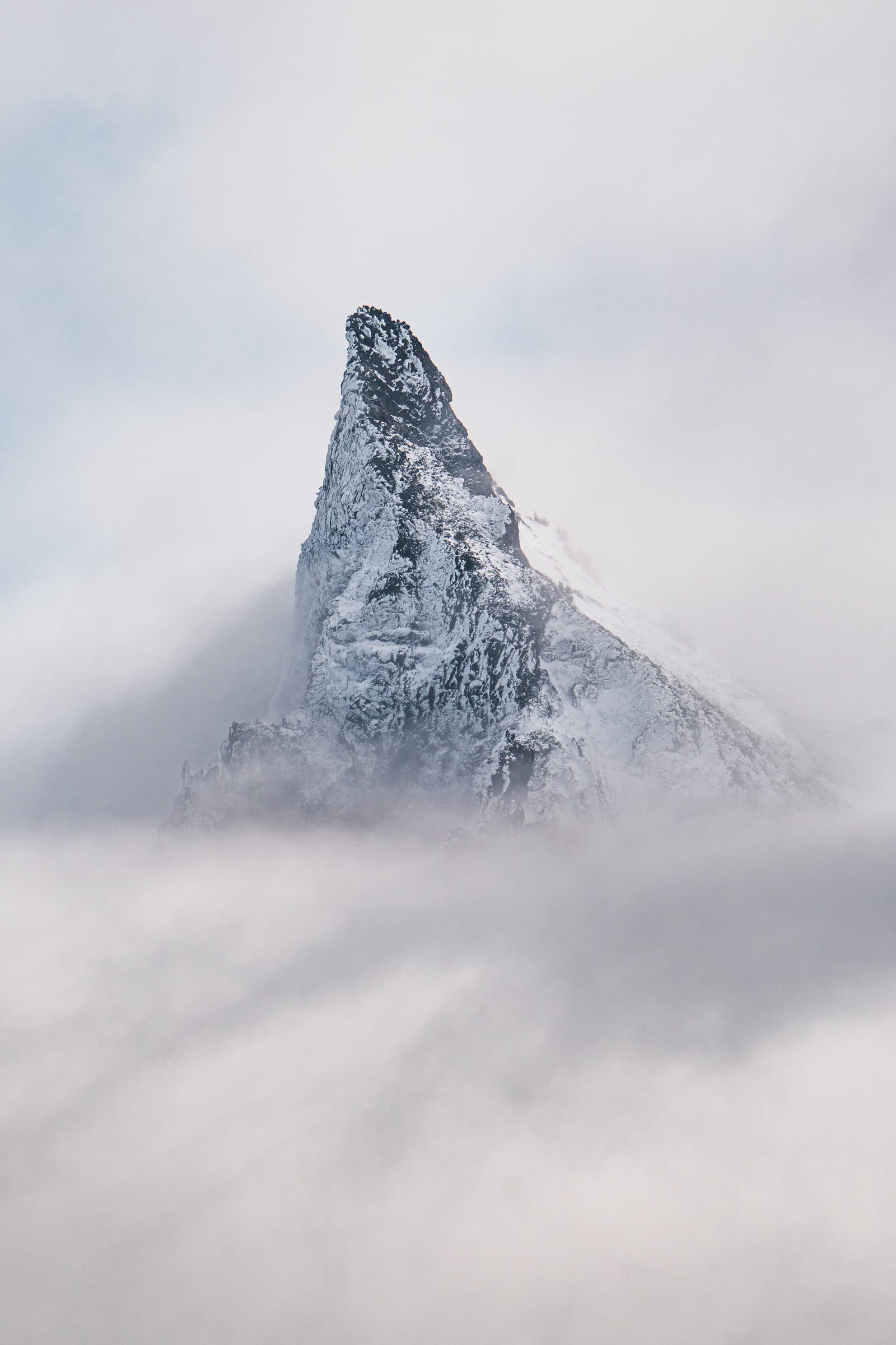 The rocky summit of Mount Thielsen rising out of cloud in October