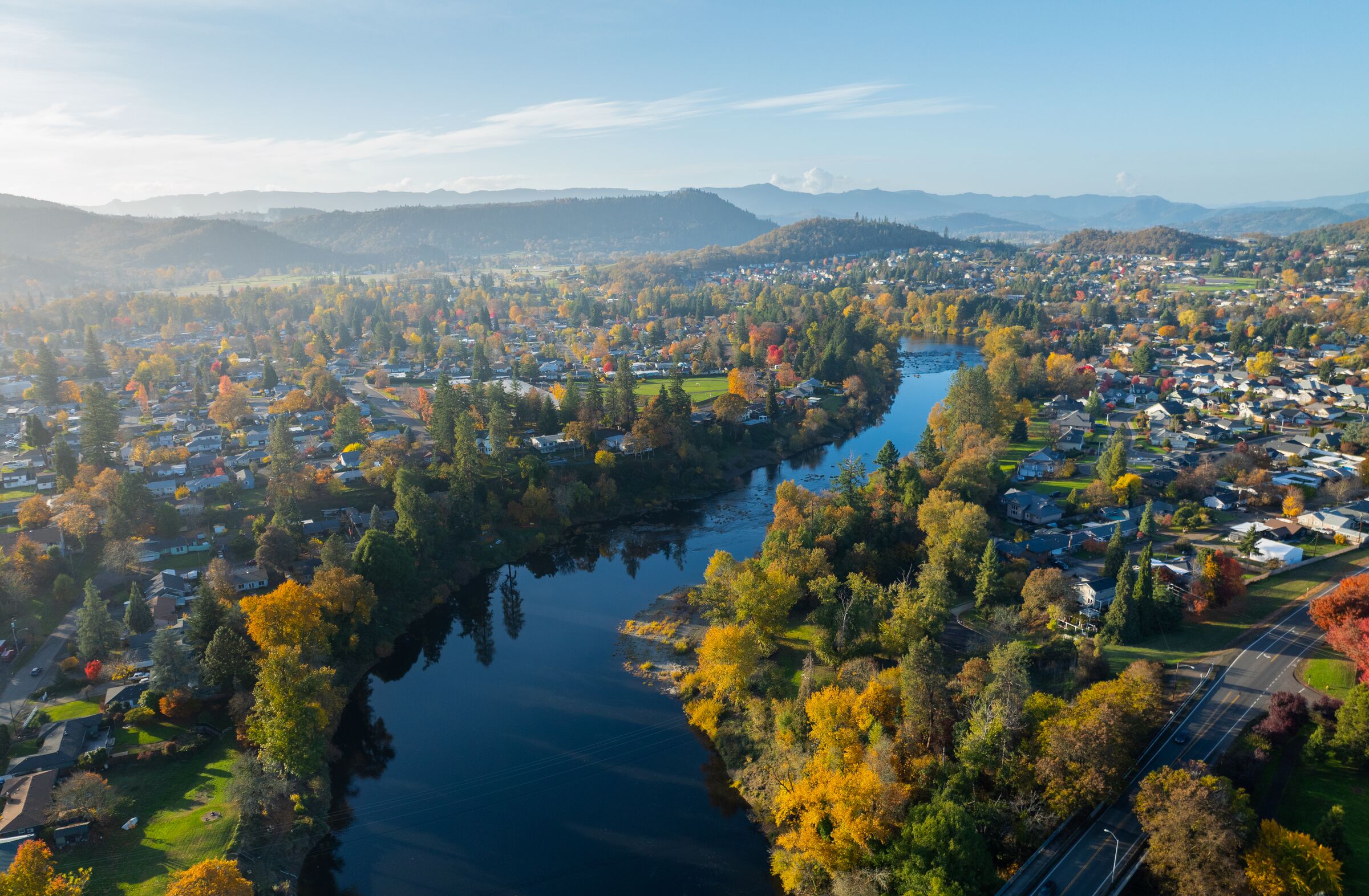 The South Umpqua River bending past Stewart Park in Roseburg in November, yellow trees along both banks